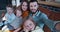 Selfie family portrait, happy young Caucasian husband taking photo with wife and three children at home slow motion.