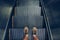 Selfie of feet in sneaker shoes on escalator steps in vintage style