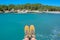 Selfie of hiking shoes, mediterranean blue water background in Menorca, Balearic islands Spain