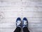 Selfie hipster feet on wooden floor background.