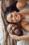 Selfie, love and black couple portrait in bedroom happy and funny while laughing on bed at home or hotel. Top view smile