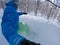 SELFIE: Male rider carving between trees on freshly fallen snow on his snowboard