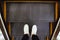 Selfie of man feet in white sneaker shoes on escalator steps in the shopping mall top view in vintage style