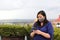 Selfie with mobile phone of Latina tourist woman with protection mask on terrace with cathedral view in San Miguel de Allende, Gu