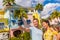 Selfie photo couple tourists taking picture with smart phone in Fort Myers, Florida at colorful wood beach cottages. USA