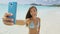 Selfie smart phone girl taking mobile phone photo on beach vacatio