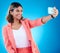 Selfie, smile and business woman in studio isolated on a blue background. Photographer, professional and Indian female