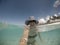 Selfie of a smiling middle aged woman in hat and shades in sea a