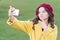 Selfie star. Small girl take selfie with smartphone outdoor. Little child V gesture to selfie camera in mobile phone