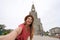 Selfie of stylish young woman in Canela, Brazil. Fashion girl takes self portrait with the church of Our Lady of Lourdes, Canela,