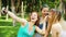 Selfie time of female friends covered with colorful powder after Holi festival