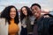 Selfie time with Group of diverse friends taking at trendy party on rooftop terrace