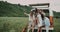 Selfie time in the middle of field , group of young ladies taking pictures sitting in the back of a retro van.