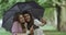 Selfie time for two ladies on rain day taking pictures using a phone , under the umbrella.4k