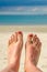 Selfie of woman bare feet, beach and sea