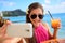 Selfie woman drinking drink at beach vacation bar