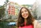 Selfie woman taking self portrait with typical italian village on the background. Girl holding smartphone camera to take a picture