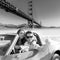 Selfie of young couple convertible car Golden Gate