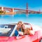 Selfie of young couple convertible car Golden Gate