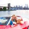 Selfie young couple convertible New York Brooklyn Bridge