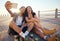 Selfie of young skater friends with phone smile and laugh at the beach. Cool cheerful man and woman smiling and having