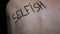 Selfish written on female body closeup, bullying victim suffering pressure