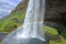 Seljalandsfoss Waterfall with Beautiful Rainbow in Southern Iceland