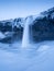 Seljalandsfoss waterfall, Iceland. Icelandic winter landscape. High waterfall and rocks. Snow and ice.