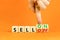 Sell on or off symbol. Businessman turns wooden cubes and changes word Sell off to Sell on. Beautiful orange table orange
