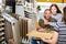 Seller advises married couple in choosing a laminate in hardware store