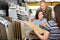 Seller advises married couple in choosing a laminate in hardware store