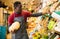 Seller arranging squash on greengrocery counter