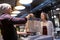 Seller giving paper bag to customer at vegan cafe