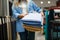 Seller holds stack of fabric in textile store