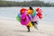 Seller of inflatable toys and swimming laps goes along the beach in island Mauritius
