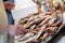 The seller is laying out the red striped mullet fishes or Mullus surmuletus on ice for sale in the greek fish shop.