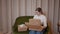 Seller merchant packing products in cardboard boxes - prepares parcels for delivery to customers, work from home