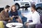 Seller offering exclusive car to marriage watching brochure in the showroom