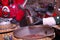 Seller pouring tasty mulled wine into cup at winter fair