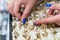 Seller`s hands showing earrings in gold shop