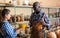 Seller and visitor in pottery souvenir shop