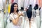 Seller in wedding salon correcting dress on mannequin