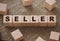 Seller word on wooden cubes on canvas burlap background. Business concept