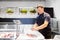 Seller wrapping fish into paper at seafood shop