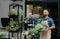 Selling plants in flower shop, opening store and small business in city, outdoor