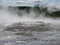 Seltun / Krysuvik KrÃ½suvÃ­k: Fumarole emit sulphur gas behind geothermal field with puddles of hot water