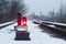 Semaphore on the railway in winter, glowing red. Gloomy scene