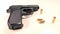 Semi-automatic handgun with golden teargas cartridges, beauty-shot