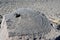 Semi-circular stone with a hole on the shore of the sacred Tibetan lake Teri Tashi Namtso