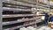 Semi-empty shelves with canned goods in the supermarket due to the coronovirus epidemic